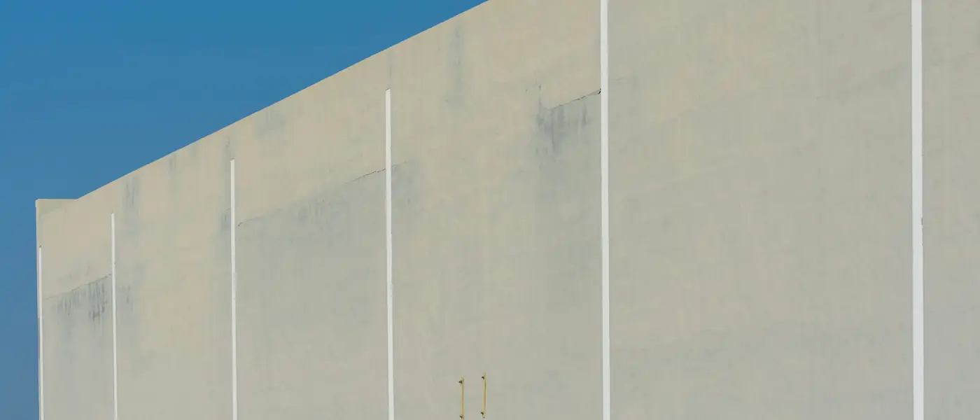 Minimal concrete commercial building facade in flat daylight