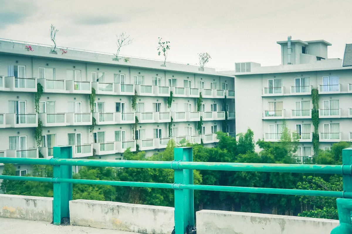 Low-rise apartment building among mature trees