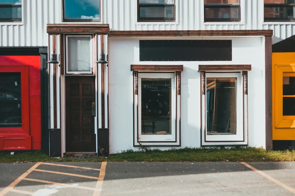 A row of small commercial storefronts along a city street